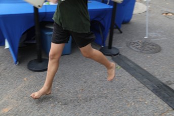 Barefoot runner at the finishline, 2-Mile Fun Run, EDA 2023